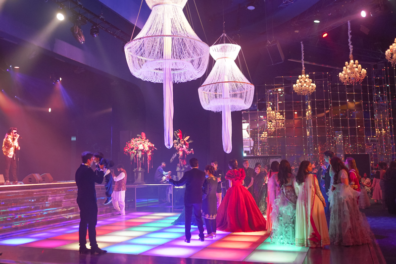 Wedding guests dancing in salle des etoiles in Moanco